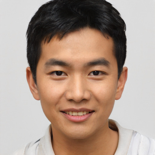 Joyful asian young-adult male with short  black hair and brown eyes