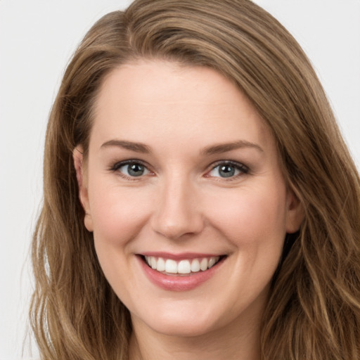 Joyful white young-adult female with long  brown hair and green eyes