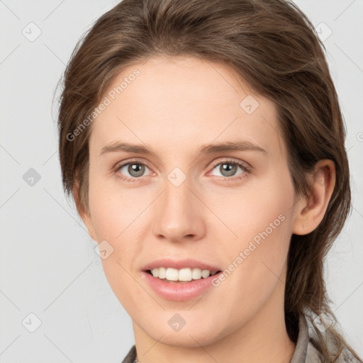 Joyful white young-adult female with medium  brown hair and grey eyes