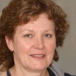 Joyful white adult female with medium  brown hair and blue eyes