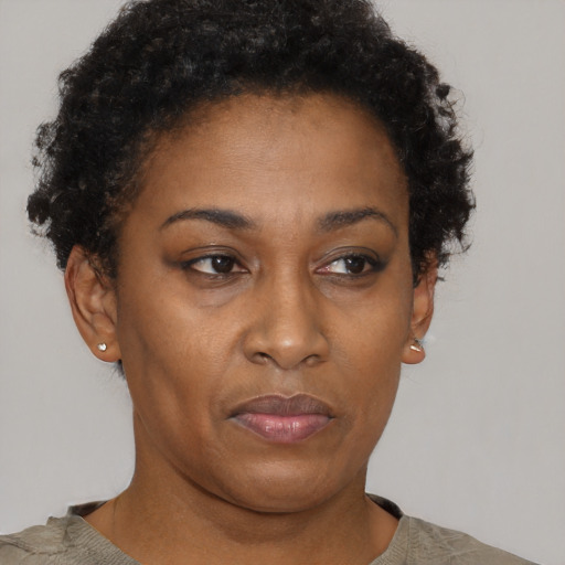 Joyful black adult female with short  brown hair and brown eyes