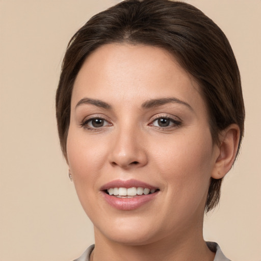 Joyful white young-adult female with medium  brown hair and brown eyes