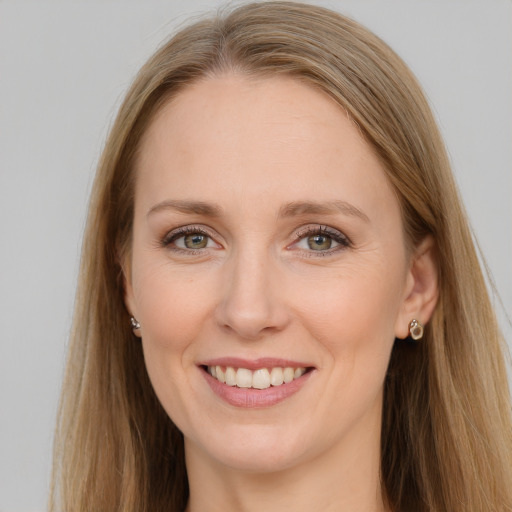 Joyful white young-adult female with long  brown hair and blue eyes