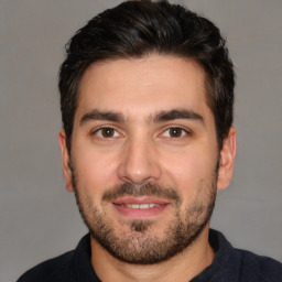 Joyful white young-adult male with short  black hair and brown eyes