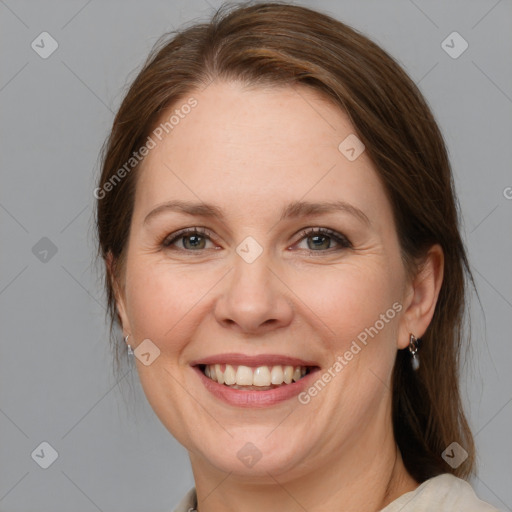 Joyful white adult female with medium  brown hair and blue eyes