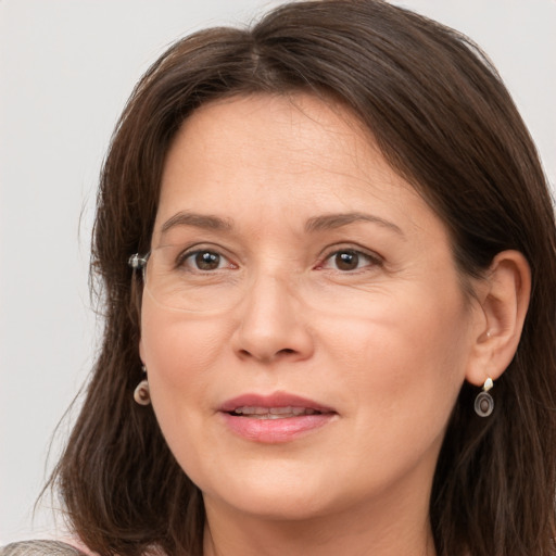 Joyful white adult female with medium  brown hair and grey eyes