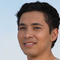 Joyful asian young-adult male with short  brown hair and brown eyes