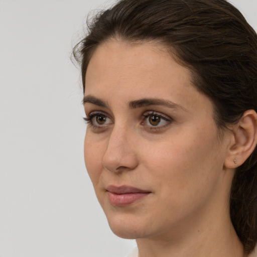 Joyful white young-adult female with medium  brown hair and brown eyes