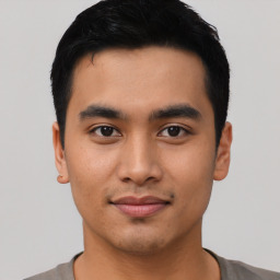 Joyful asian young-adult male with short  black hair and brown eyes