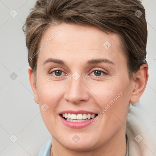 Joyful white young-adult female with short  brown hair and grey eyes