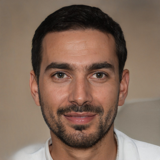 Joyful white young-adult male with short  black hair and brown eyes