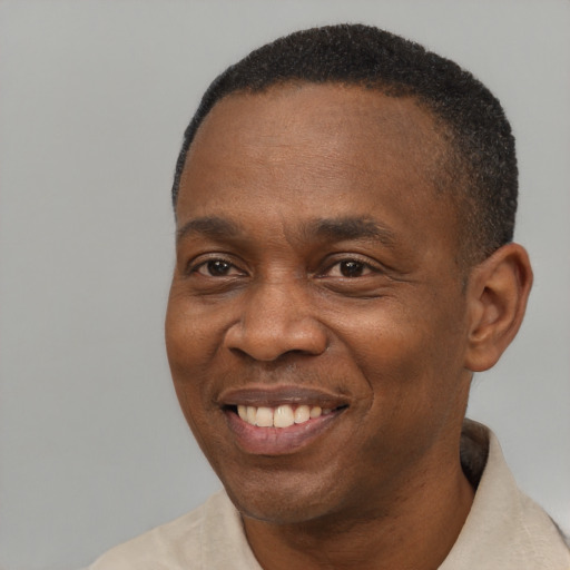 Joyful black adult male with short  brown hair and brown eyes