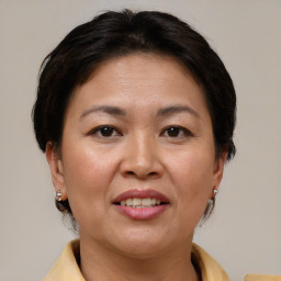 Joyful white adult female with short  brown hair and brown eyes