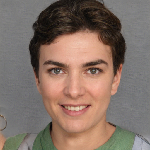 Joyful white young-adult female with short  brown hair and grey eyes