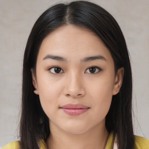 Joyful asian young-adult female with long  brown hair and brown eyes