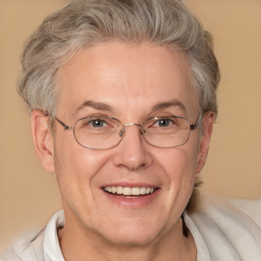 Joyful white middle-aged male with short  gray hair and brown eyes