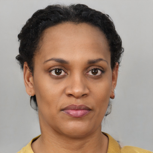 Joyful latino adult female with short  brown hair and brown eyes