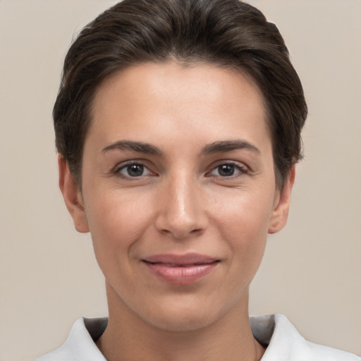 Joyful white young-adult female with short  brown hair and brown eyes