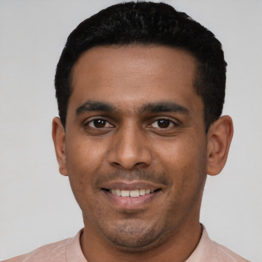 Joyful latino young-adult male with short  black hair and brown eyes