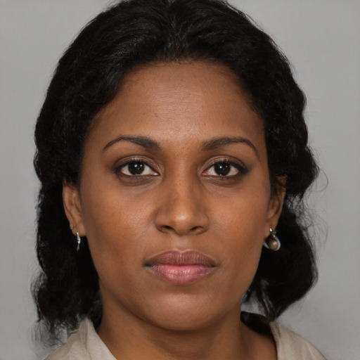Neutral black young-adult female with medium  brown hair and brown eyes