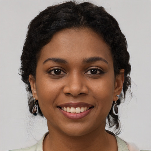 Joyful black young-adult female with short  brown hair and brown eyes