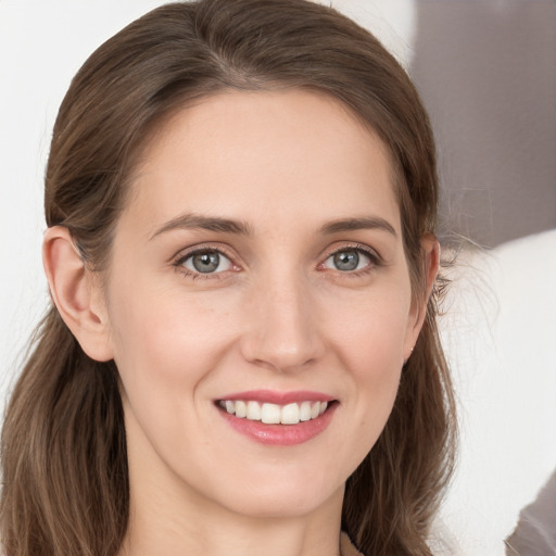 Joyful white young-adult female with long  brown hair and grey eyes