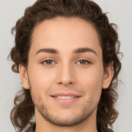 Joyful white young-adult male with medium  brown hair and brown eyes