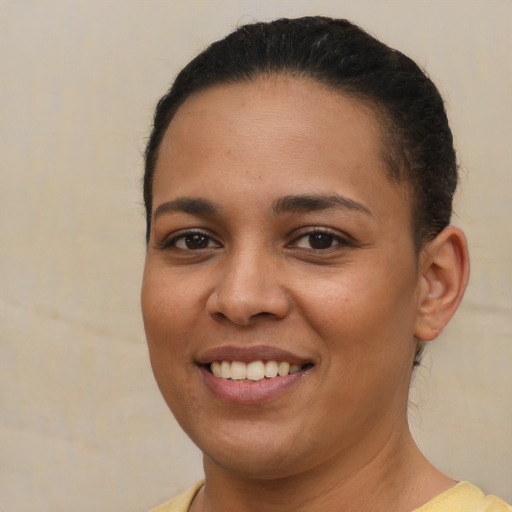 Joyful latino young-adult female with short  brown hair and brown eyes