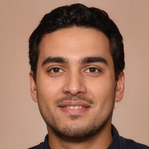 Joyful latino young-adult male with short  black hair and brown eyes