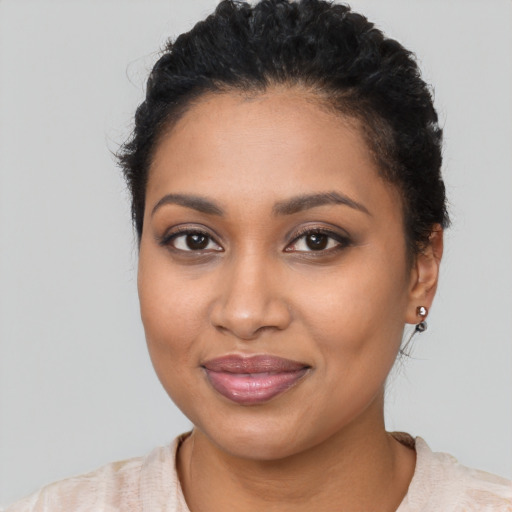 Joyful latino young-adult female with short  black hair and brown eyes