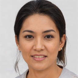 Joyful latino young-adult female with medium  brown hair and brown eyes