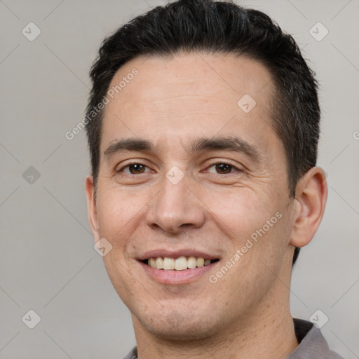 Joyful white adult male with short  brown hair and brown eyes