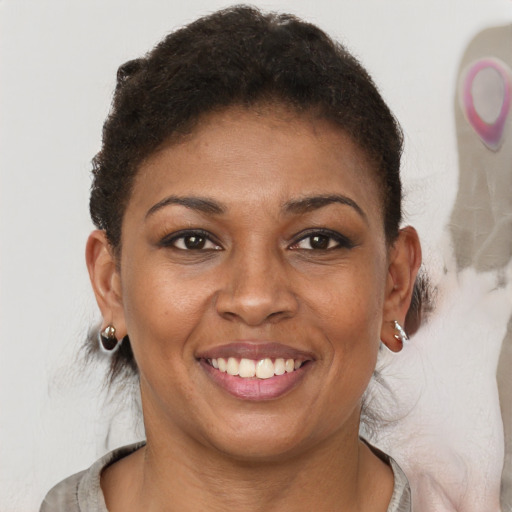 Joyful black young-adult female with short  brown hair and brown eyes