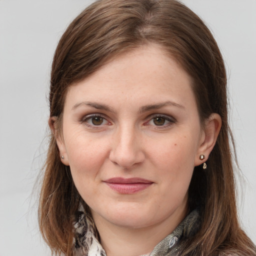 Joyful white young-adult female with long  brown hair and grey eyes