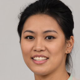 Joyful asian young-adult female with medium  brown hair and brown eyes