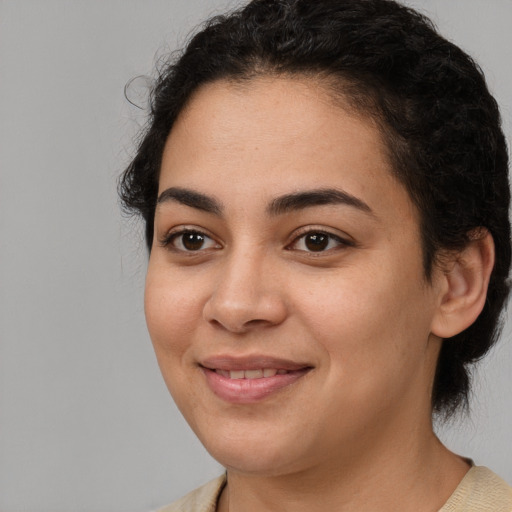 Joyful latino young-adult female with short  brown hair and brown eyes