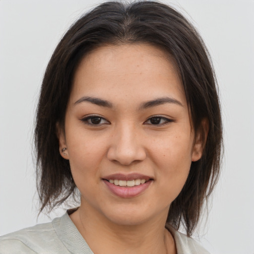 Joyful asian young-adult female with medium  brown hair and brown eyes