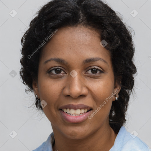 Joyful black adult female with medium  brown hair and brown eyes