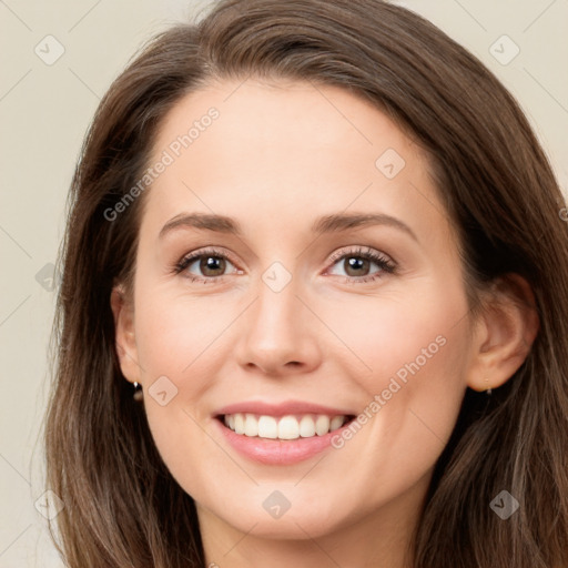 Joyful white young-adult female with long  brown hair and green eyes