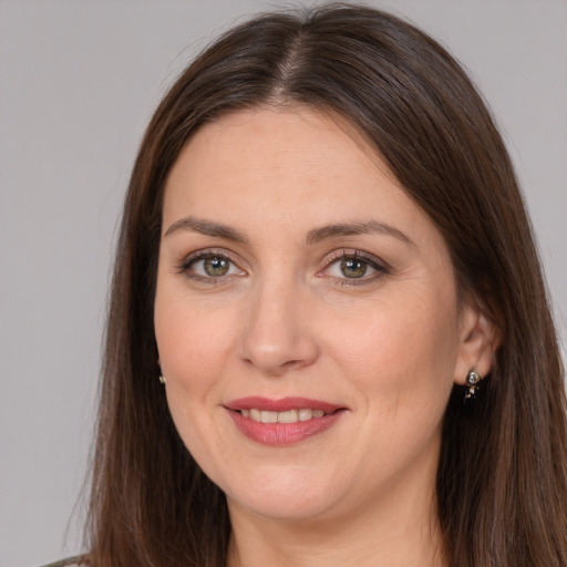 Joyful white adult female with long  brown hair and brown eyes