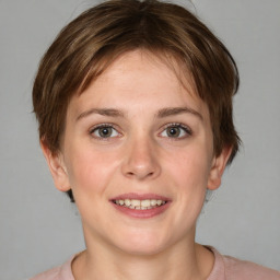 Joyful white young-adult female with medium  brown hair and grey eyes