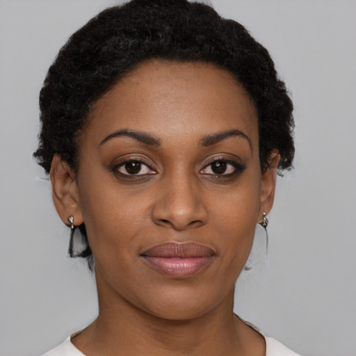 Joyful black young-adult female with short  brown hair and brown eyes