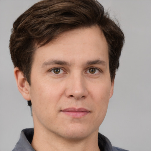 Joyful white adult male with short  brown hair and grey eyes