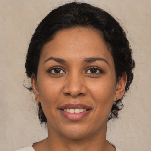 Joyful latino young-adult female with medium  black hair and brown eyes