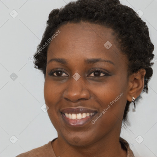 Joyful black young-adult female with short  brown hair and brown eyes