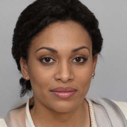 Joyful black young-adult female with short  brown hair and brown eyes