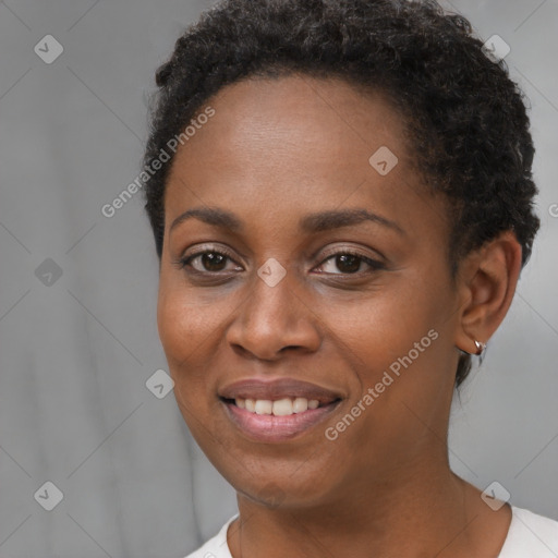 Joyful black young-adult female with short  brown hair and brown eyes