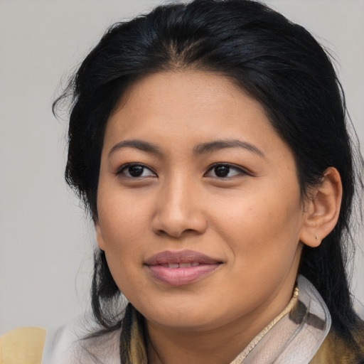 Joyful asian young-adult female with long  black hair and brown eyes