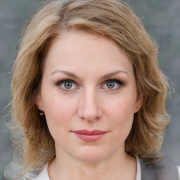 Joyful white young-adult female with medium  brown hair and blue eyes