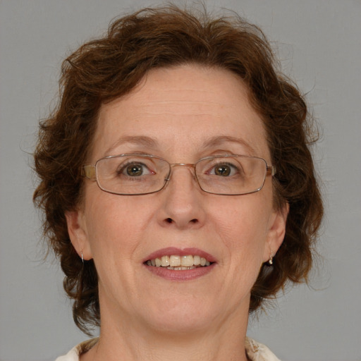 Joyful white middle-aged female with medium  brown hair and blue eyes